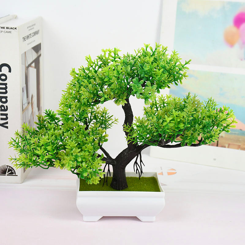 Decorative artificial bonsai tree with dense green leaves and a textured dark trunk in a white ceramic planter—perfect for office desks or home décor accents.