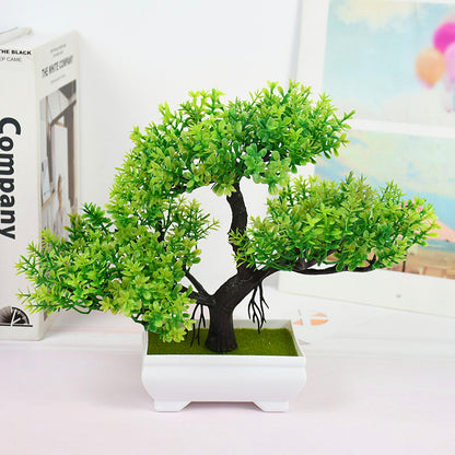 Decorative artificial bonsai tree with dense green leaves and a textured dark trunk in a white ceramic planter—perfect for office desks or home décor accents.